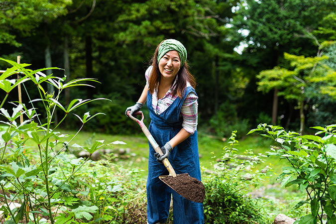 A woman digs soil